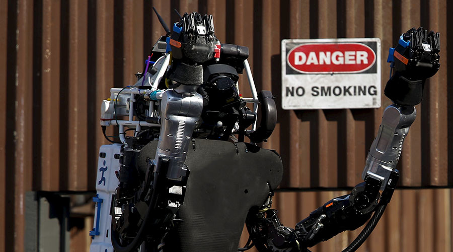 The Team IHMC Robotics Atlas "Running Man" robot built by Boston Dynamics raises its arms to celebrate after climbing the stairs during the finals of the Defense Advanced Research Projects Agency (DARPA) Robotic Challenge in Pomona, California