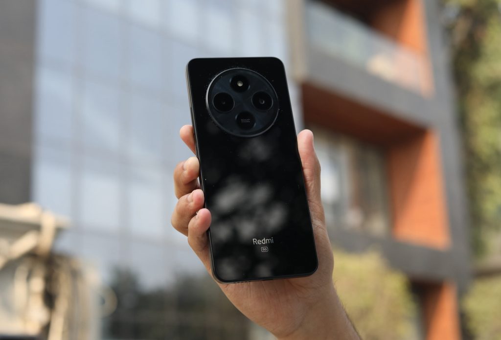 Image of a person holding the Redmi A4 5G