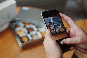 Image of a person capturing a photo with iPhone