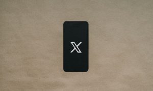 A black phone showing the X logo