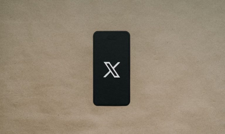 A black phone showing the X logo
