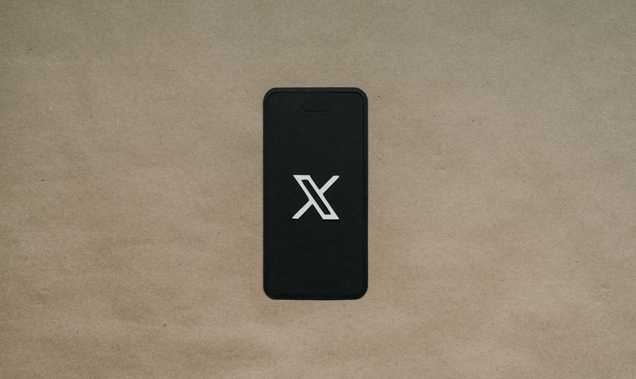 A black phone showing the X logo