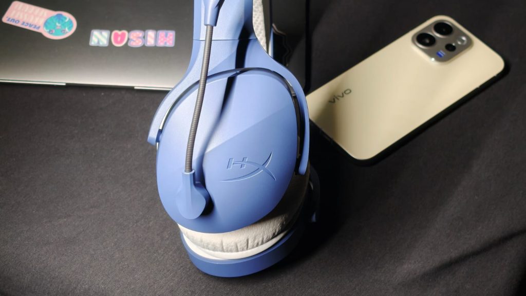 HyperX Cloud Jet Dual Wireless gaming headphones sitting on their side on a table