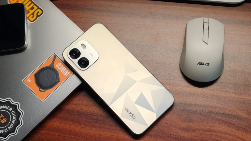 OPPO K14 kept on the side of a macbook