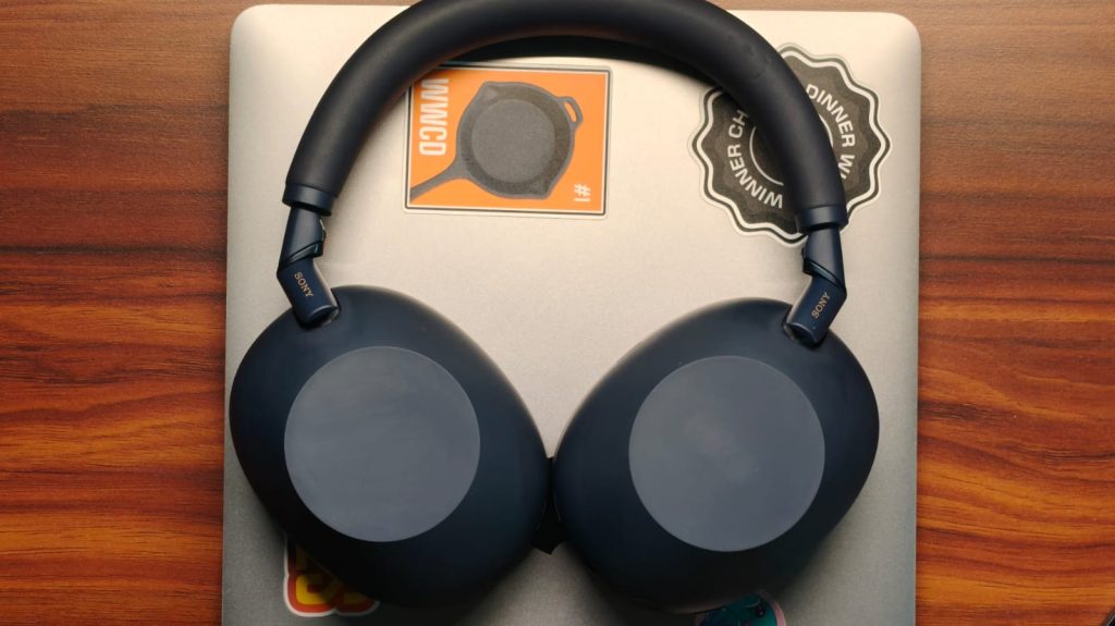 The headphones lying on top of a MacBook
