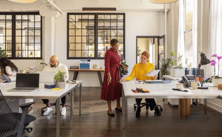 A person giving showing someone a printed paper